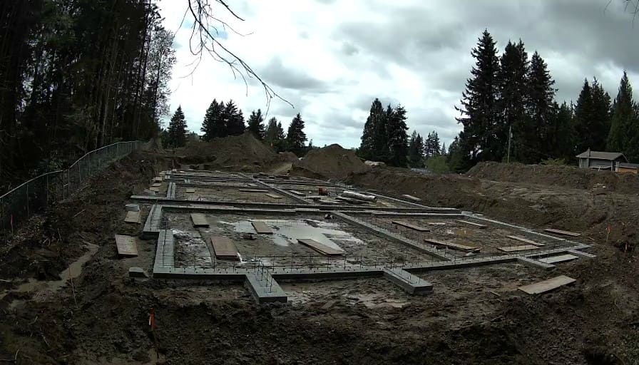 Reolink Go Ultra sample frame showing formed concrete footings with rebar at a residential build
